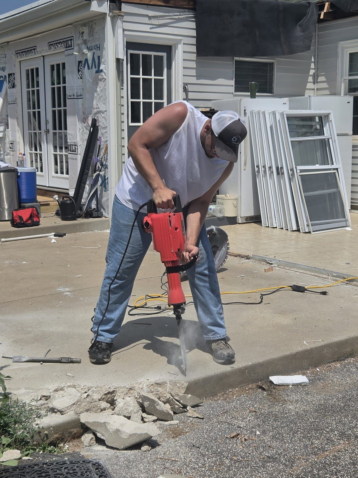 Joshua DeHaas breaking up concrete on a job site